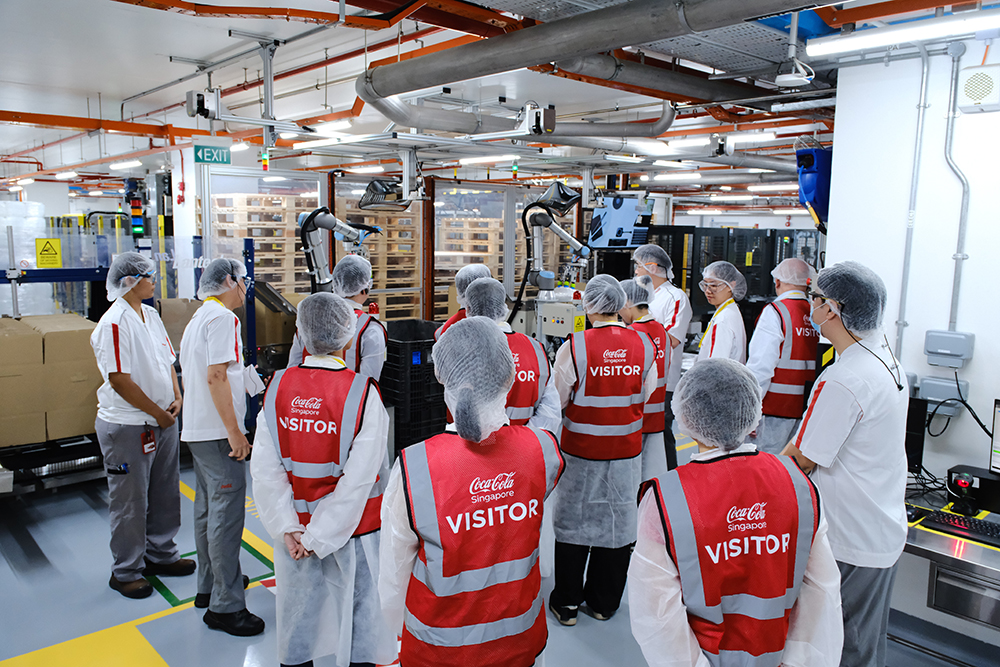 smart robotic arms can accurately pick and handle ingredient bags to help workers at Coca-Cola