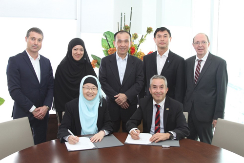 At the signing of the MOU in Singapore