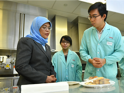 President Halimah in CNRC’s test kitchen- speaking to Mr Melvin Koh