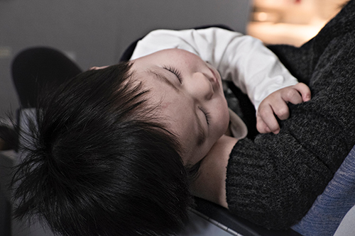 Baby asleep with mum