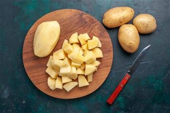 top-view-sliced-fresh-potatoes-vegetables-dark-blue-background